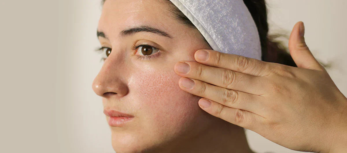 A close-up of a woman’s face highlighting large pores, illustrating skincare concerns and products for minimizing pores
