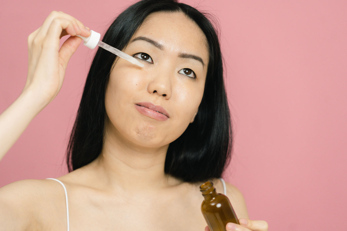 Woman applying skincare product to her face