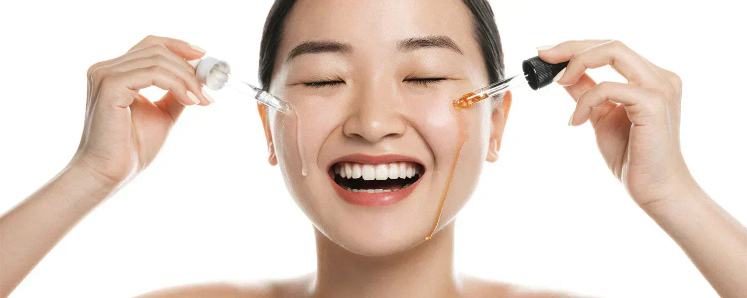 Woman applying two different facial skincare products