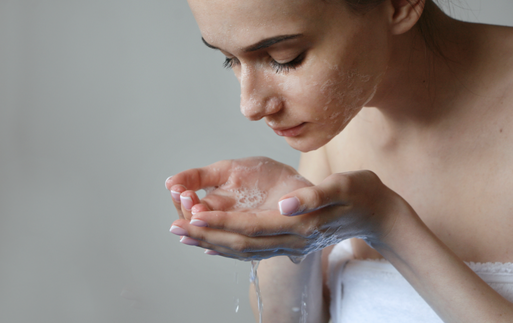 Woman washing her face